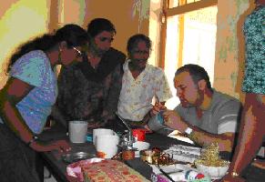 David (SOS Malta) demonstrating how to paint some crafts to women involved in the Matara micro-enterprise project